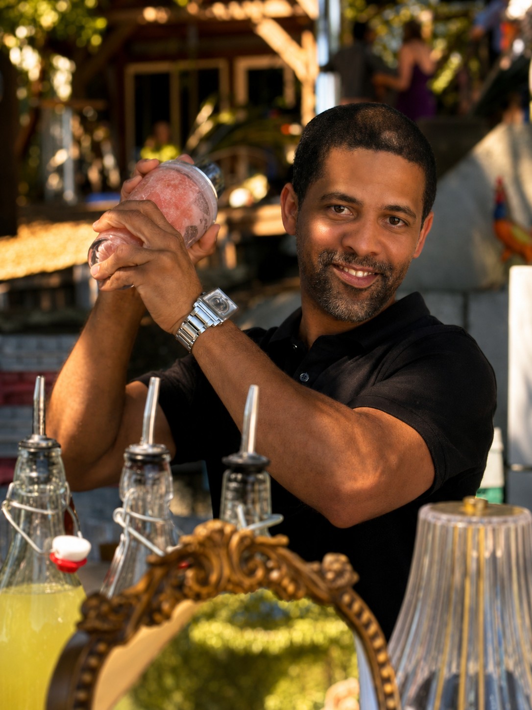 Jorge preparing cocktails behind the bar