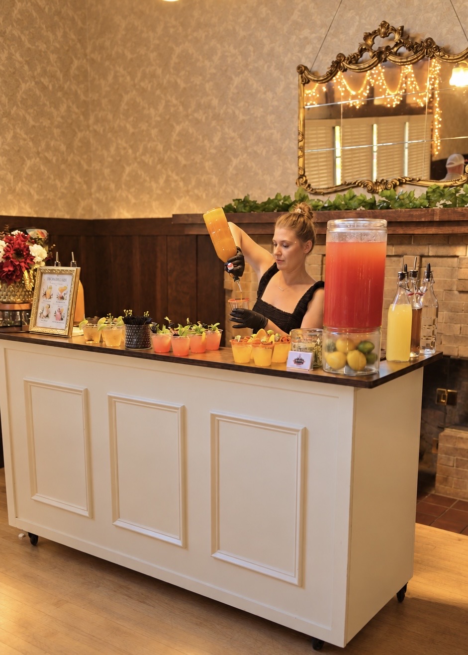 Jessica preparing signature cocktails behind the bar during the reception rush